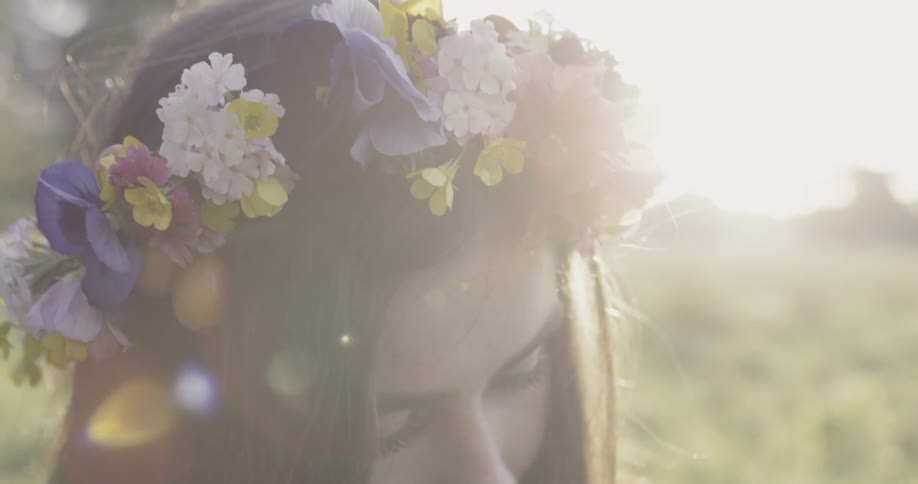 Woman wears a flower wreath on her head on a sunny day
