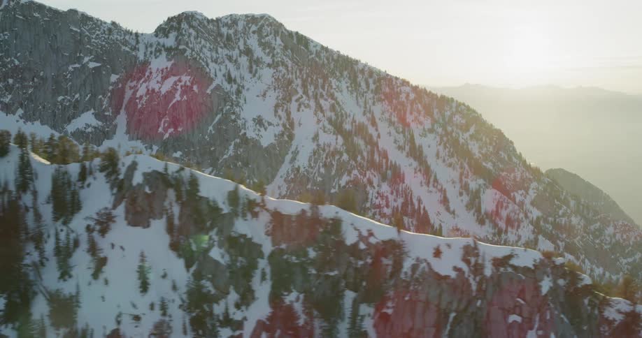 Trees and snow on mountain ridges on a sunny day