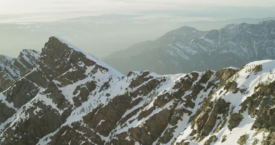 Snow cover mountain peaks are flown over