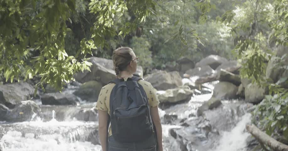 Woman hikes near a river
