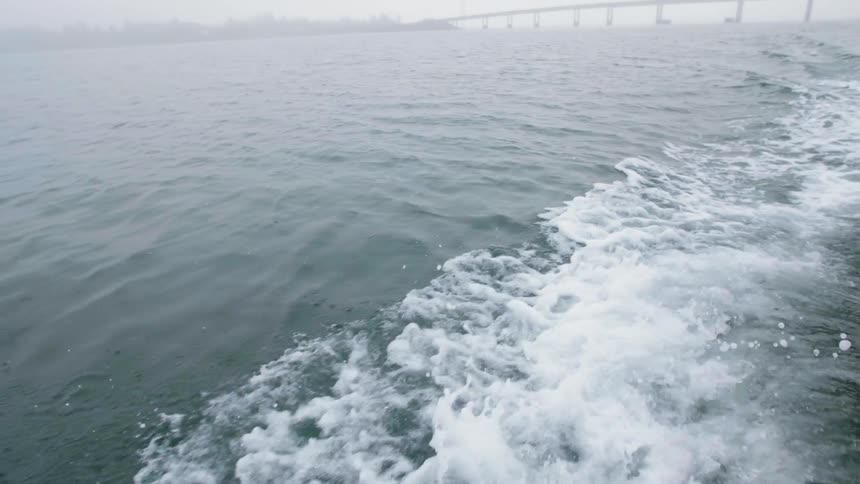 Foamy waves crash in the rough water