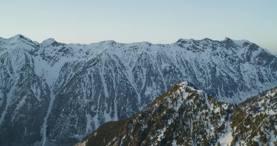 The large mountain range is covered with snow