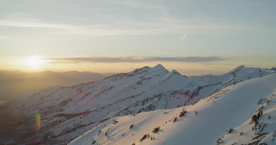 Bright sun shines on the snow covered mountains