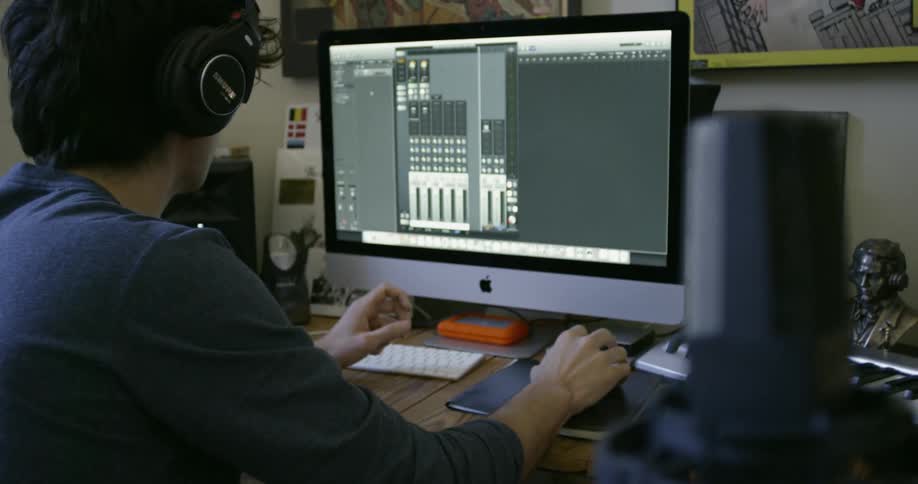 Someone is editing music on their computer