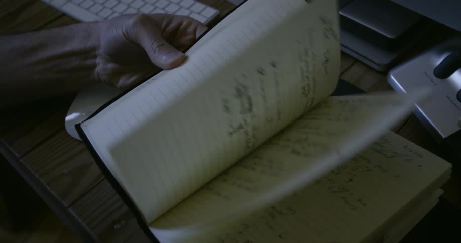 Someone is flipping through a notebook full of notes