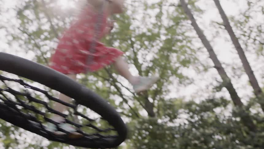 Girl plays on a backyard swing