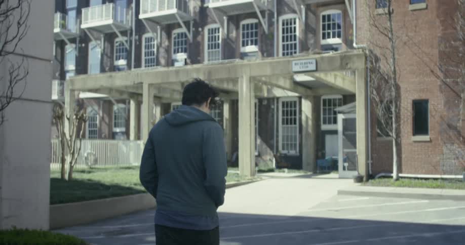Man walks near a city building