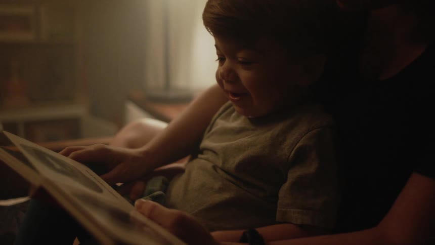 Mother and son read a book at home
