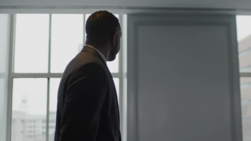 Man walks past windows in a building