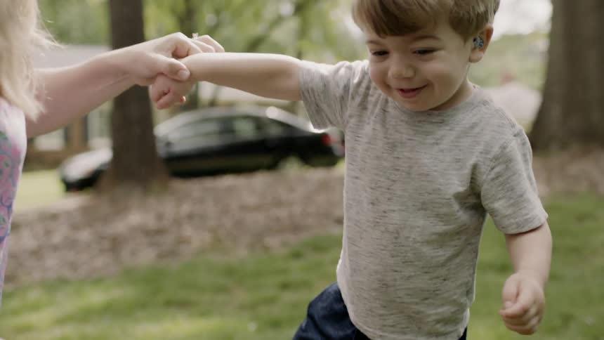A mom and a child are playing outside