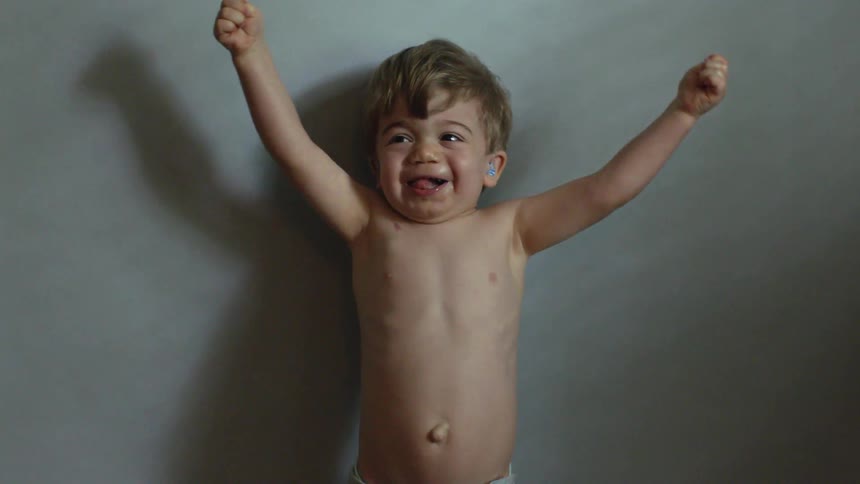 Toddler dances and waves his arms