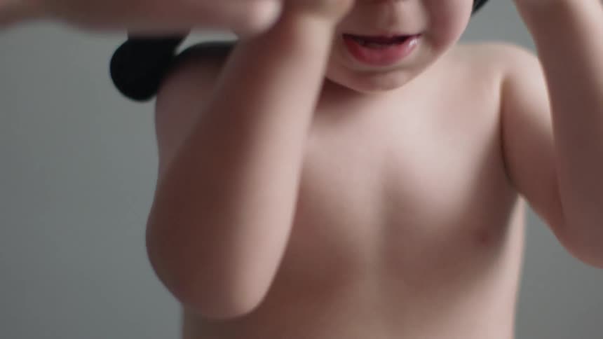 Young boy takes off his shirt