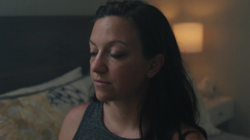 Woman stares off to the side