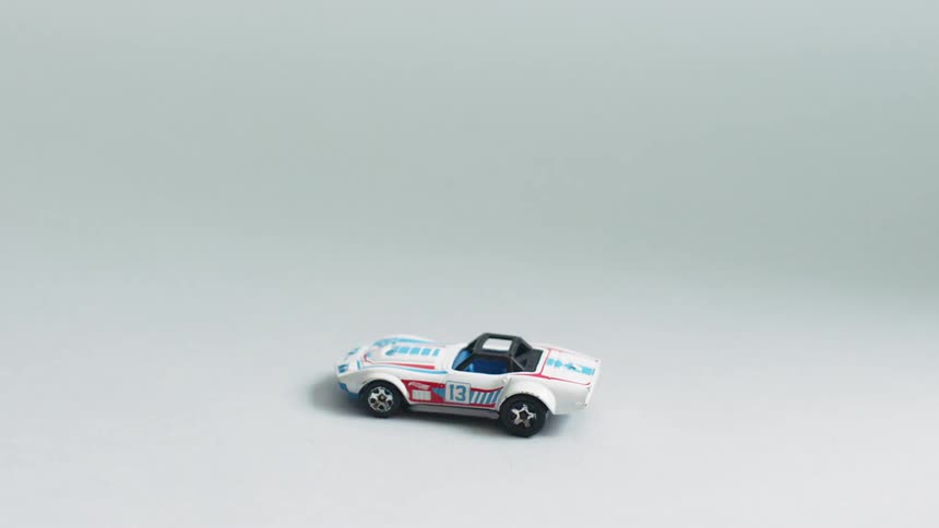 Toy white dinky car sits undisturbed