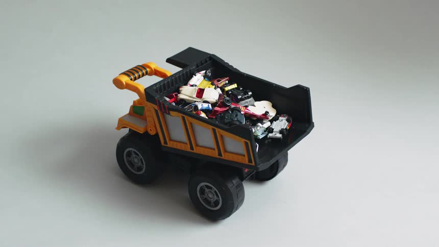 A toy dump truck sits on the floor