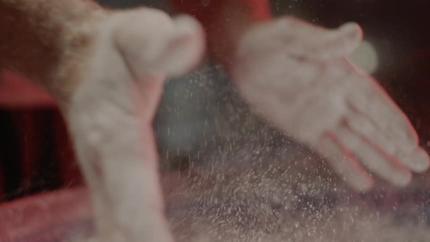 Man spreads flour on his hands and then claps them together