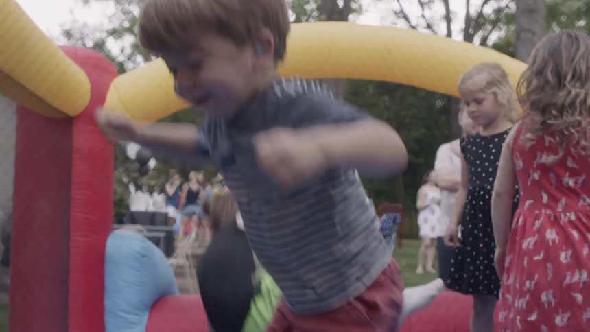 A bunch of kids are jumping around a bouncy castle
