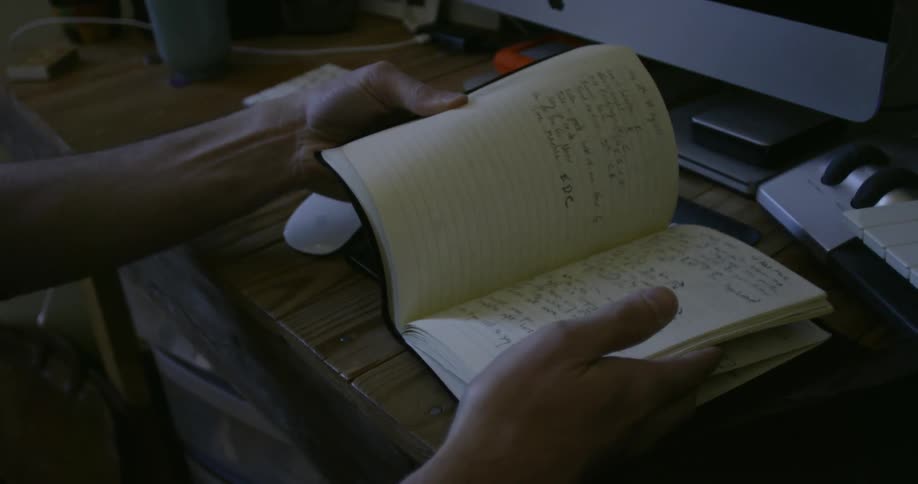 Person turns the pages of a notebook