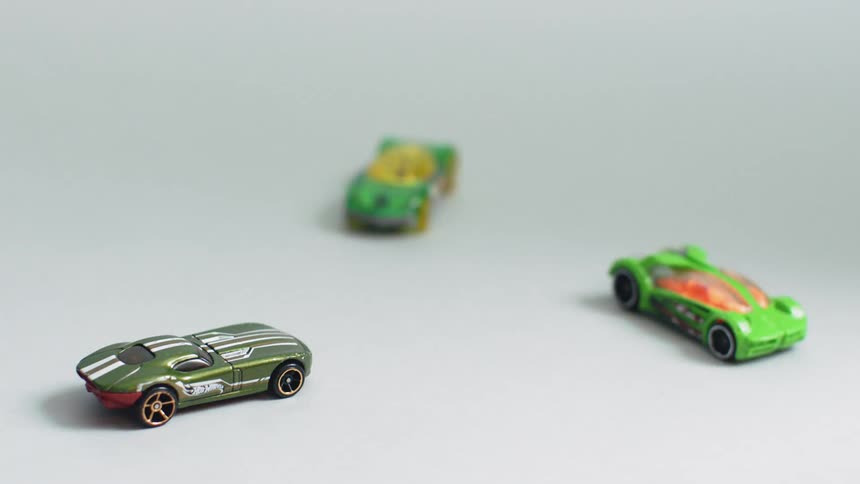 Toy cars sit on a floor