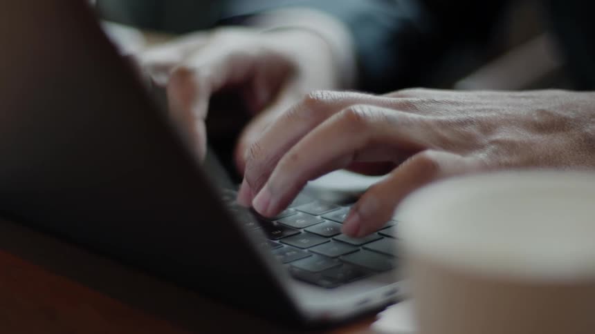 Person typing on a keyboard