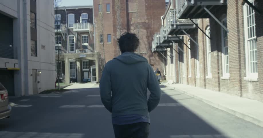 Man walks down a busy city street