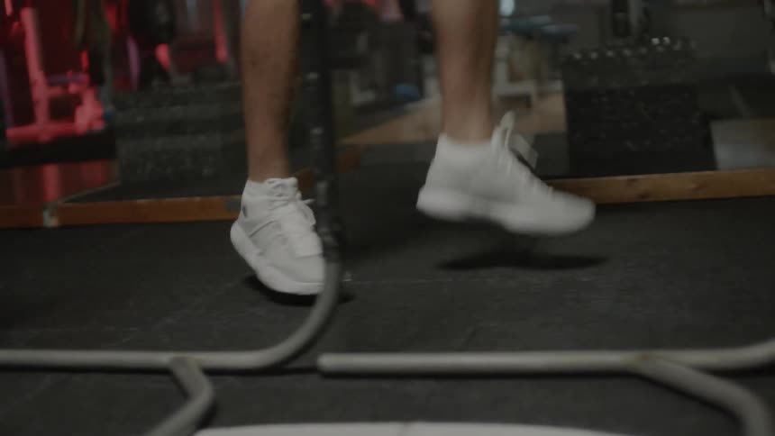 Man jumps and exercises in a gym