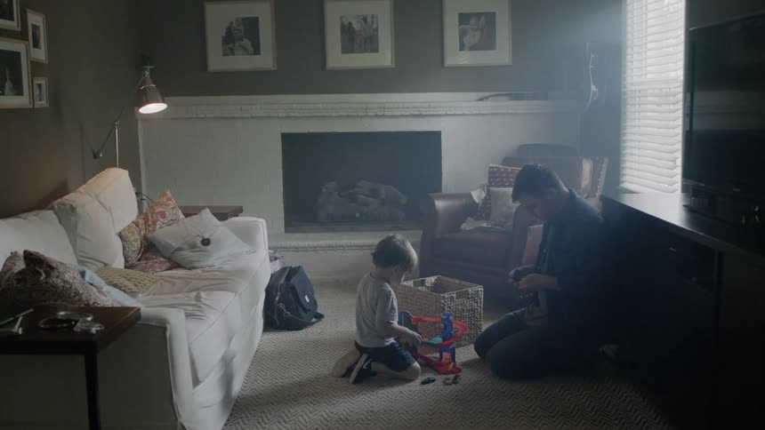 Adult and child playing with toys on a living room floor