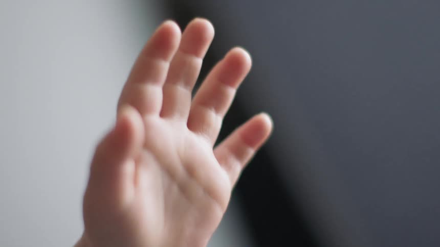 A child holds his hand up
