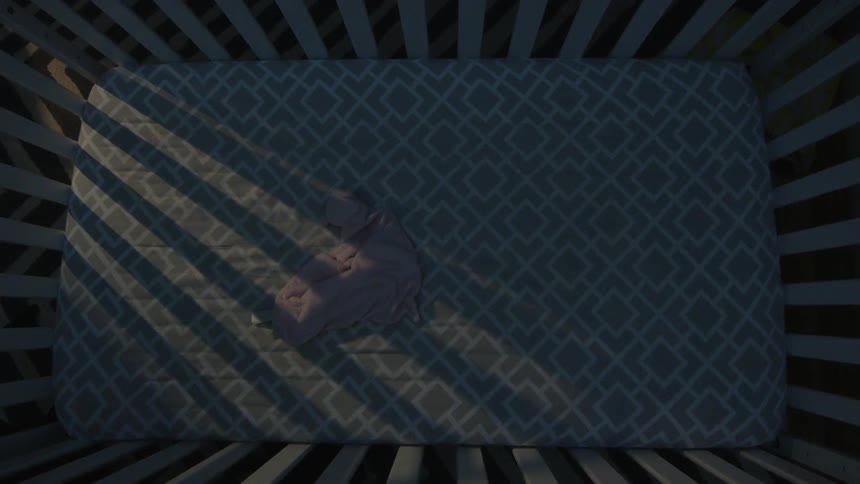 A blanket sits in a crib