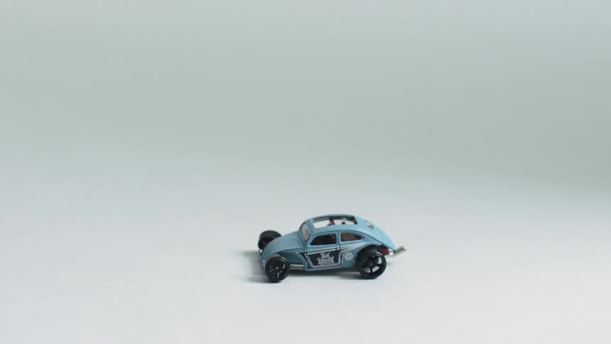 A toy car is sitting idle on a surface
