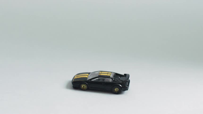 Black toy car with yellow stripes