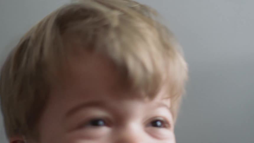 Smiling boy wears hearing aids