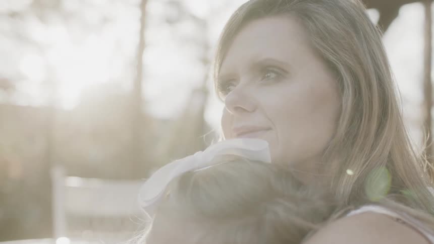 A woman consoles her young daughter