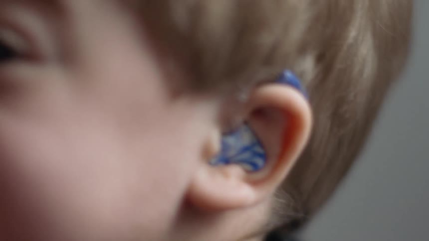 Young boy wears hearing aids