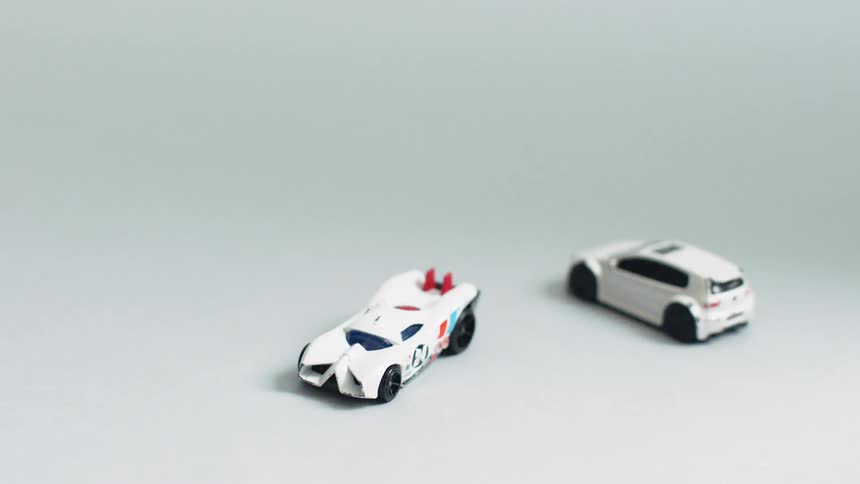 Toy cars sit on a floor