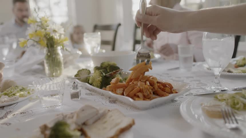 A family are sitting together at a table eating