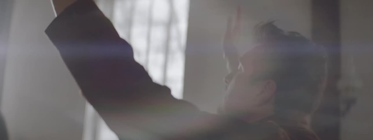 A man raises his hands in a preaching gesture