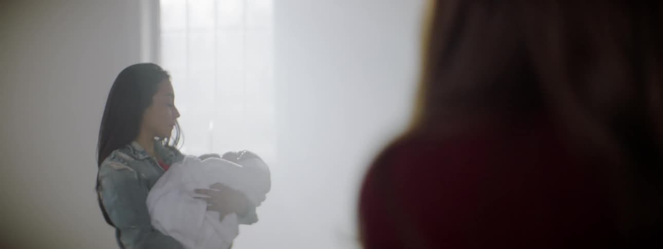 A woman is holding a baby in church