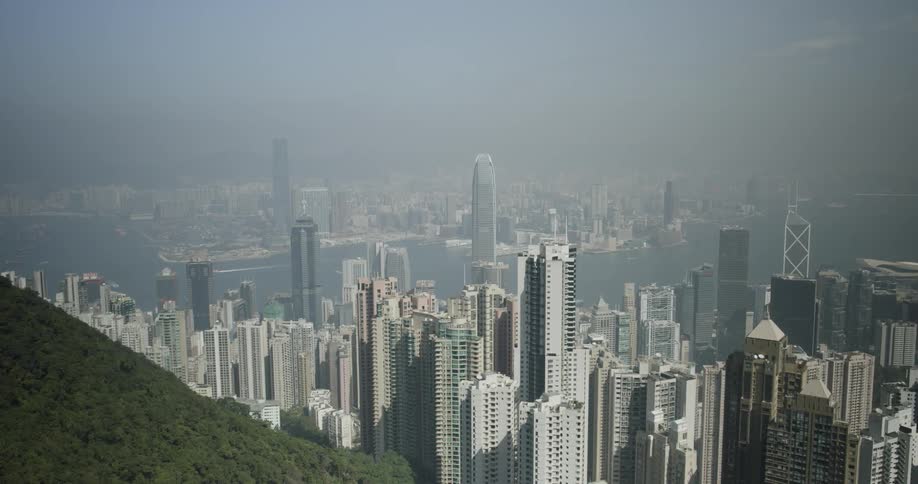 Tall buildings and skyscrapers in city on smoggy day
