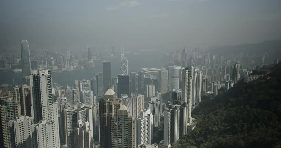 Tall buildings and skyscrapers in city on smoggy day