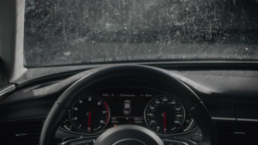 Water splashes on the windshield of a car