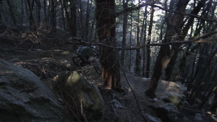 Man riding his bike fast down a very steep cliff