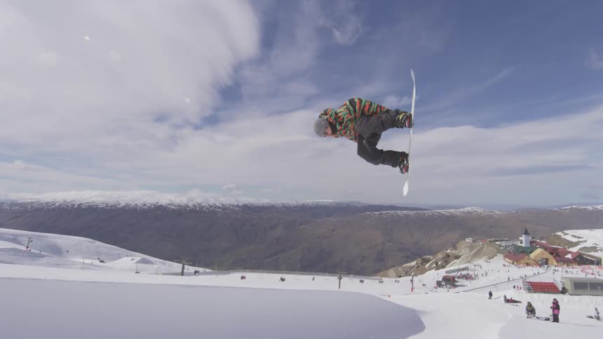 Man snowboarding and jumping on ramp