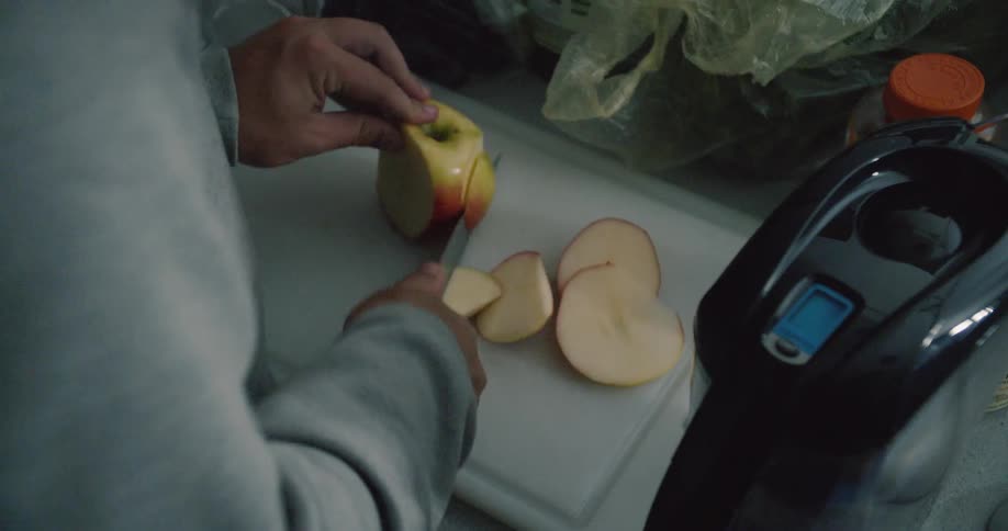 An apple is sliced on a cutting board