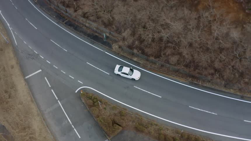 White car turns right onto the highway