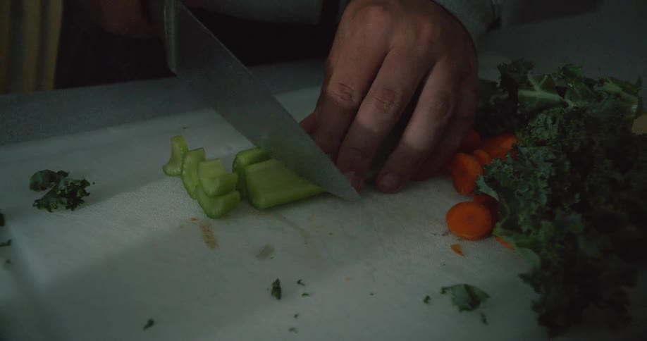 Person cuts celery on a cutting board