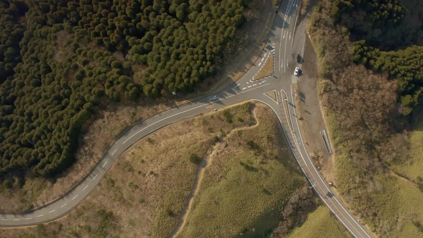Road winds through grassy tree covered plains