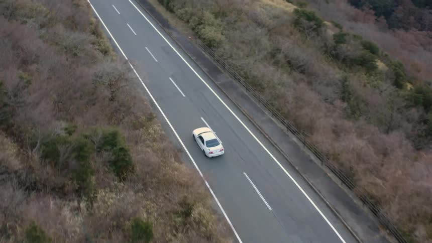 Car traveling on mountain highway during the day