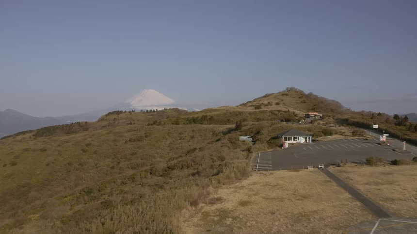Cars travel on a road on top of a hill
