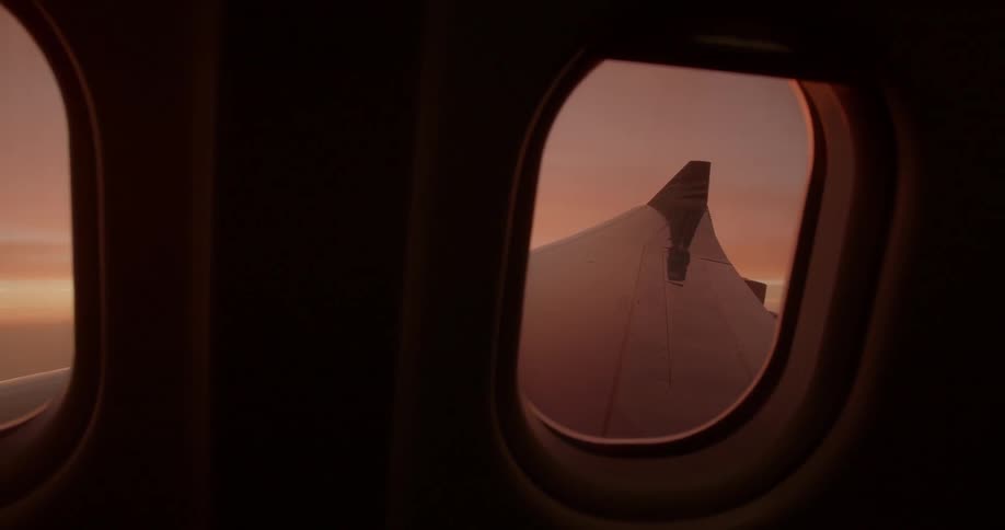 Bright sun shines through the windows of an airplane